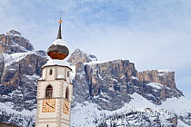 The church and village of Colfosco in Badia (1645m) and Sella Massif range of Mountains under winter snow, Dolomites, South Tirol, Trentino Alto-Adige, Italy 2009