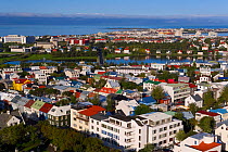 Low aerial view from Hallgrimskirkja of the colourful houses, commercial buildings and harbour of the capital city Reykjavik, Iceland 2006