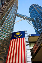 National flag of Malaysia against Petronas Towers - 88 storey steel clad twin towers with a height of 451.9 metres - the iconic symbol of Kuala Lumpar, Selangor, Malaysia 2008
