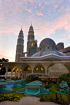 Mosque in the KLCC city park grounds at the base of Petronas Towers at night - 88 storey steel clad twin towers with a height of 451.9 metres - the iconic symbol of Kuala Lumpar, Selangor, Malaysia 20...