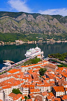 Large cruise liner docked in the harbour next to the Old Town, Fjord and mountains from the Walls of the Kotor Fortress which forms a continuous belt around the Old Town of Kotor, Bay of Kotorska, Adr...