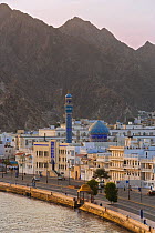 Mutrah Corniche with latticed white buildings and Mosque with the mountains behind, Muscat, Oman 2007