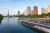 View of River Seine with sight-seeing boat with high-rise buildings and Eiffel Tower, Paris, France 2011