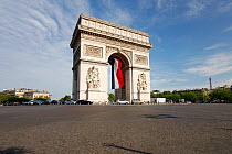 French flag under Arc de Triomphe built by Napoleon, Etoile, Paris, France 2011