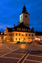 Piata Sfatului, the centre of medieval Brasov, the Council House (Casa Sfatului), from 1420 topped by a Trumpeter's Tower, this old city hall today houses the Brasov Historical Museum - illuminated at...