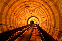 Blurred motion light trails in an train tunnel under the Huangpu river linking the Bund to Pudong, Shanghai, China 2010