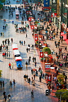Looking down on pedestrians walking past stores on Nanjing Road, Shanghai, China 2010