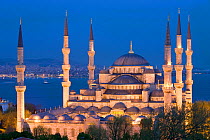 Elevated view of the Blue Mosque in Sultanahmet, illuminated at dusk, overlooking the Bosphorus river in Istanbul, Turkey 2008