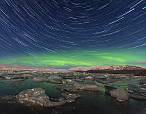 Aurora borealis and star trails over Jokulsarlon glacier lagoon. Southern Iceland, Europe, August 2012.