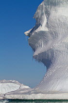 Iceberg formations eroded to resemble human face in profile. Antarctica