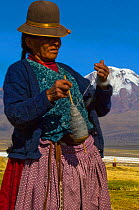 Aymara shepherdess spining llama wool, Sajama. Bolivia, October 2011. No release available.
