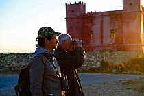 Chris Debono of BirdLife Malta and volunteer at Red Tower watchpoint soon after dawn, monitoring hunters and bird migration BirdLife Malta Springwatch Camp, April 2013