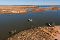 Aerial view of the Cooper Creek Crossing with a 'punt' or ferry servicing the vehicle driving public to cross the road, South Australia, June 2011