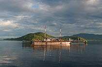 Fishing device called Bagan, a stationary outrigger boat, with a net between outriggers and strong light at night to attract anchovies and scad. Cenderawasih Bay, Papua Province, Indonesia, April 2012