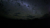 Timelapse of the Milky Way galaxy revolving due to the Earth's rotation, with moonrise and clouds, footage taken at night using starlight camera technology, Moremi Game Reserve, Botswana, April 2009.