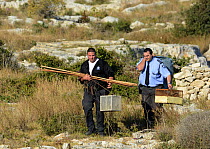 ALE (Administrative Law Enforcement) Police with confiscated turtle doves (Streptopelia turtur) and equipment from dove trapping area, Malta, during Birdlife Malta Springwatch Camp, April 2013