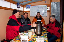 Lunch time inside the main wooden cabin on sledges, Arctic circle Dive Center, White Sea, Karelia, Northern Russia, March 2010