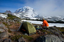 Backpacker camping near Seattle Park in Mount Rainier National Park. Washington, USA. Model released.
