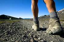 Hiker's legs and boots crossing the Plains of Abraham on the Loowit Trail #216 in Mount St Helens National Volcanic Monument. Washington, USA, August 2011. Model released.