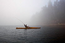 Fly fishing from a kayak in the Straits of Juan De Fuca near Sail and Seal Rocks. Washington, USA, August 2012.