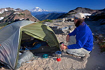 Hiker camping above the Goat Flats along the Pacific Crest Trail in the Goat Rocks Wilderness, Gifford Pinchot National Forest. Washington, USA, August. Model released.