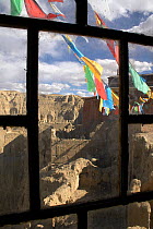 Buddhist prayer flags outside window frame at Tsaparang (sometimes known as the mythical Shangri-la) was the capital of the ancient kingdom of Guge in the Garuda Valley, Ngari Prefecture, Western Tibe...