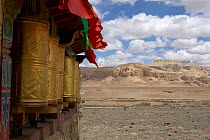 Prayer wheels enscribed with 'Om mani padme hum' prayer chant, on the side of a stupa, Tholing (Zanda) Gompa, Ngari Prefecture, Tibet, June 2010