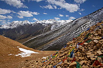 Prayer flags left on slopes, with view to the South East down the Karnali River Valley from the Nara Lagna pass (4580m / 15,026ft) on the Nepal / Tibet border, Humla, Nepal, June 2010