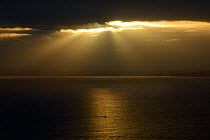 Sun rays between clouds over calm sea, Morgat, Crozon pennisula, Brittany, France, November 2012