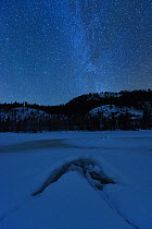 Frozen lake at night in under the Milky Way. Flatanger, Norway, January 2010.