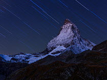 RF- Matterhorn (height 4,478m) at night, with star trail, taken from Schwarzsee. Zermatt, Switzerland, September 2012. Composite image. (This image may be licensed either as rights managed or royalty...