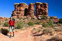 Hiker on the Elephant Hill 4-wheel drive trail in the Needles District. Canyonlands National Park, Utah, October 2012. Model released.
