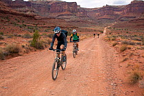 Mountain bike ridders on the White Rim Road near Shafer Trail junction. Canyonlands National Park, Utah. Model released.