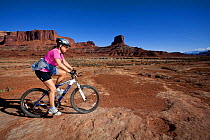 Mountain biker between Airport and Gooseberry along the White Rim Road in the Island In The Sky District. Canyonlands National Park, Utah, October 2012. Model released.