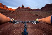 Perspective of mountain biker over handlebars, Taylor Canyon, Island In The Sky District. Canyonlands National Park, Utah, October 2012. Model released.