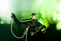 Scuba diver under ice, Arctic circle Dive Center, White Sea, Karelia, northern Russia, March 2010
