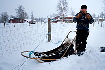 Lauri, a guide for sled dogs excursions inside Riisitunturi National park explaining how to drive the sledge, Lapland, Finland