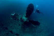 Diver on the wreck of the Italian cargo ship 'Umbria' looking at the Starboard propellor, scuttled in Port Sudan 10th June 1940, Red Sea, March 2008