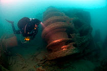 Diver inspecting forward winch on the 'SS War knight' sunk by collision, fire, mine and gunfire during the 1st World War. Freshwater Bay. Isle of Wight, May 2010