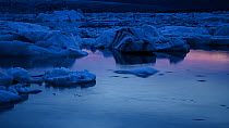 Timelapse of icebergs moving in Jokulsarlon glacial lagoon at twilight, formed from meltwater from the retreating Vatnajokull glacier, Iceland, July 2012.
