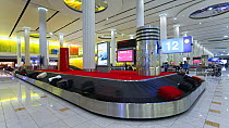 Timelapse of luggage on the Terminal 3 baggage carousel in the Arrivals Hall, Dubai International Airport, Dubai, United Arab Emirates, 2011.