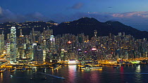 Timelapse from day to night overlooking Hong Kong Island towards Victoria Peak, Victoria Harbour and the Financial District, Hong Kong, China, 2011.