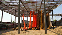 Timelapse of newly dyed Sari fabric being hung up to dry in a Sari factory, Rajasthan, India, 2011.
