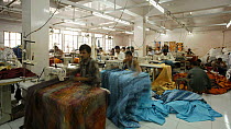 Timelapse of factory workers using sewing machines in a garment factory, Rajasthan, India, 2011.