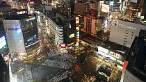 Wide timelapse shot of crowds of people crossing the centre of Shibuya shopping and entertainment district, Tokyo, Japan, 2011.