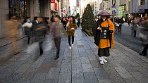 Timelapse of a Shinto priest seeking donations on the main shopping street in Ginza, Tokyo, Honshu, Japan, 2011.