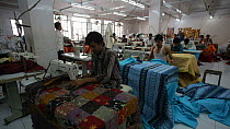 Factory workers using sewing machines in a garment factory, Rajasthan, India, 2011.