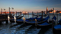 Gondolas tied to a quay at St Mark's Square looking towards San Giorgio Maggiore Island, Venice, Italy, 2011.