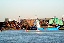 Boat loading or unloading scrap metal, River Thames, London, England UK, February 2007