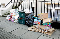 Post Christmas consumer packaging outside house along with full recycling bins, London Borough of Islington, London, UK